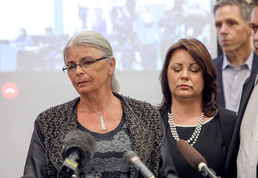 Lee Cook (left) and Laura Baanstra (second from left) at a news conference Friday in Everett, where two county sheriffs announced the arrest of a suspect in the 1987 slayings of Jay Cook, 20, and his girlfriend, Tanya Van Cuylenborg. Lee Cook is Jay Cooks mother, and Baanstra is his sister. (Lizz Giordano / The Herald)