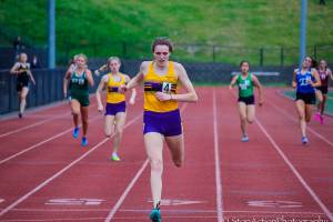 Photo courtesy of Don Borin/Stop Action Photography                                Issaquah Eagles senior Elise Burdette, center, registered a first place finish in the 400 with a time of 56.95 at the Class 4A District II track championships on May 18 at the Southwest Athletic Complex in Seattle.