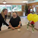 Issaquah Mayor Mary Lou Pauly serves hors doeuvres to resident Russell Waterhouse of Renton at Issaquah Nursing & Rehabilitation during a Martinis with the Mayor event last week. William Shaw/staff photo