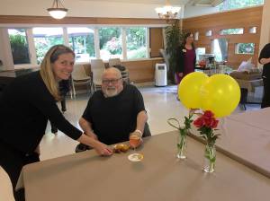 Issaquah Mayor Mary Lou Pauly serves hors doeuvres to resident Russell Waterhouse of Renton at Issaquah Nursing & Rehabilitation during a Martinis with the Mayor event last week. William Shaw/staff photo