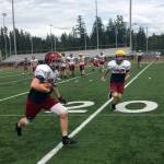 Eastlake Wolves senior Broc Stauffer hauls in a short pass before turning the ball upfield during a spring football practice session on June 5 in Sammamish.                                Shaun Scott, staff photo