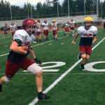 Eastlake Wolves senior Broc Stauffer hauls in a short pass before turning the ball upfield during a spring football practice session on June 5 in Sammamish.                                Shaun Scott, staff photo