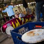 Tech team member Ron Manz gives the thumbs up as driver Tabby Holms hits the desired weight of 240 pounds in her soap box derby car during weighing at the barn June 7 on Camano Island. The 11th Stanwood-Camano Soap Box Derby takes place Saturday. (Andy Bronson / The Herald)