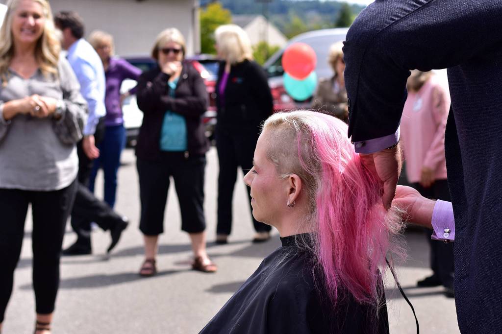 Right: A close-up of Erin Hansman getting her head shaved. Hansman is a senior analyst of customer experience at SAP Concur. Photo courtesy of Eastside Baby Corner