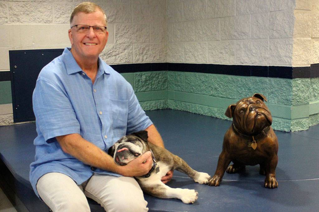 Patrick Ford sits with the real Buddy and the bronze Buddy during the unveiling. Photo courtesy of Nancy Francis