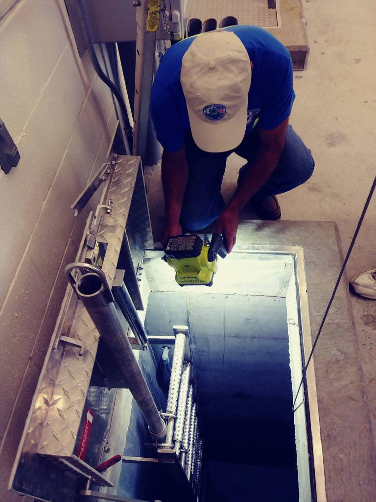 A worker at the Northeast Sammamish Sewer and Water District pump station stands above an access tunnel during a drill showing how workers will evacuate during an earthquake. Aaron Kunkler/Staff photo
