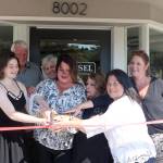 Gibson, along with her family and employees, cut the ribbon at the Carousel Gift Shop grand opening. Evan Pappas/staff photo