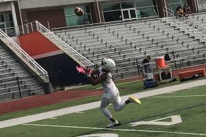 Eastside Catholic Crusaders wide receiver Gee Scott Jr. hauls in a deep pass from assistant coach Greg Prator on the second day of practice. Shaun Scott/staff photo