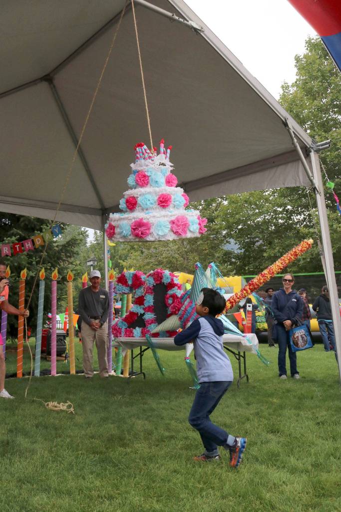 Kids try to break the pinata to get the candy inside. Evan Pappas/Staff Photo
