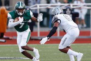 The Skyline Spartans defeated the Kentwood Conquerors, 21-14, in a nonleague matchup on Aug. 31 at Skyline High School in Sammamish. Skyline senior receiver Donovan Bahall, left, prepares to stiff-arm Kentwood defender Dyllon Daniels in the open field. The Spartans will face the Peninsula Seahawks at 7 p.m. on Sept. 7 in Purdy. Photo courtesy of Jim Nicholson