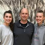The Eastlake Wolves volleyball team is led by senior outside hitter Lauren Martin, left, and junior outside hitter Anna Ilstrup, right. Former Eastlake assistant coach Mike Knapick (center) is in his first season leading the Wolves varsity program. Shaun Scott/staff photo