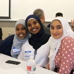 Youth discussion facilitators Hibaq, Fadumo, and Mina sit together before the discussions begin. Evan Pappas/Staff Photo