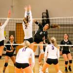 The Issaquah Eagles cruised to a 3-0 victory against the Skyline Spartans in a rivalry matchup on the volleyball court on Oct. 3 in Sammamish. Issaquah junior Maya Patton, (No. 2), leaps into the air for the block at the net against Skyline. The Eagles improved their overall record to 7-1 with the victory. Photo courtesy of Rick Edelman/Rick Edelman Photography