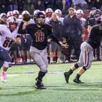 Issaquah Eagles quarterback Trevor Morine, center, unleashes a pass while being pressured by Mount Si defensive player Carlos Ortiz in the first half of play. Mount Si defeated Issaquah 38-6 on Oct. 5 at Gary Moore Stadium in Issaquah. Photo courtesy of Don Borin/Stop Action Photography
