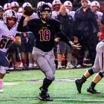 Issaquah Eagles quarterback Trevor Morine, center, unleashes a pass while being pressured by Mount Si defensive player Carlos Ortiz in the first half of play. Mount Si defeated Issaquah 38-6 on Oct. 5 at Gary Moore Stadium in Issaquah. Photo courtesy of Don Borin/Stop Action Photography