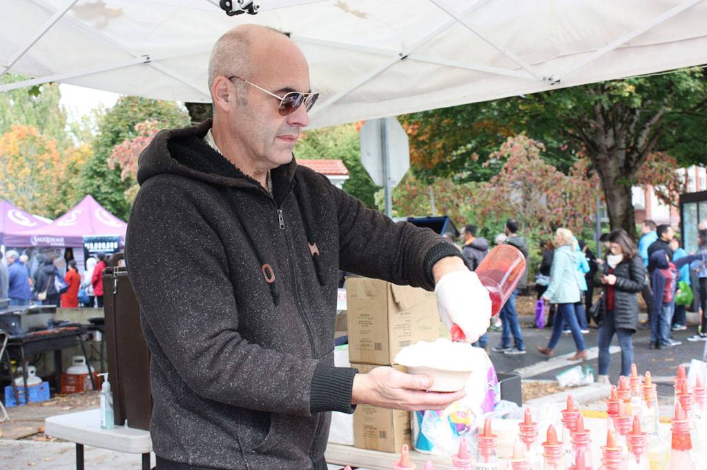 Jon Pressman, with Samijons Shaved Ice, makes one of the frozen treats during Issaquahs Salmon Days celebration. Aaron Kunkler/staff photo