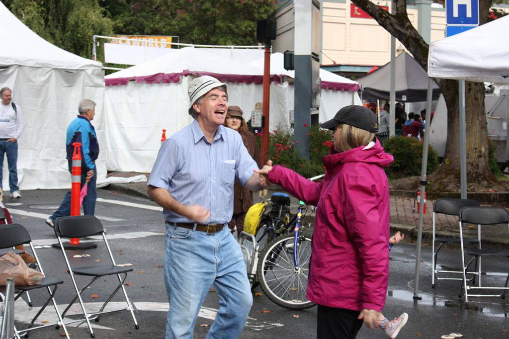Dancers swing each other around to the sounds of The Redondos at the Salmon Days Mule Stage on Sunday. Aaron Kunkler/staff photo