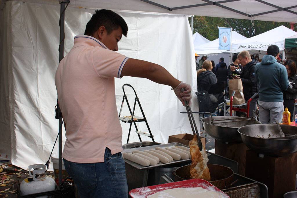 An employee makes elephant ears at Rays Elephant Ears on Sunday. Aaron Kunkler/staff photo
