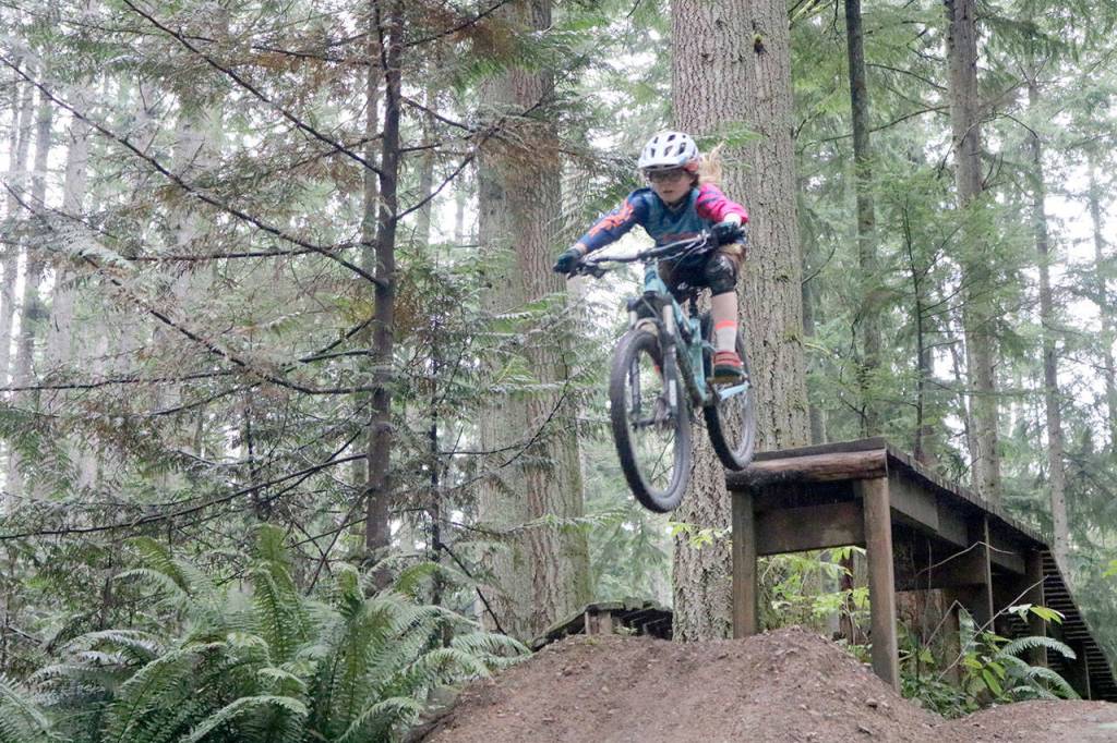 Sweetlines rider Molly Pop smoothly leaps from a large jump on the Voodoo Child trail. Evan Pappas/Staff Photo