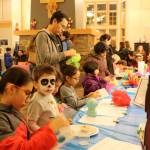 Franco Esquivel looks up after working on his arts and crafts along with many of the other kids at the event. Evan Pappas/Staff Photo