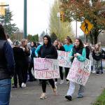 Skyline High School students and community protest perpetuation of rape culture following ISD lawsuit. Faye Danyluk holds a sign that says, Spartans Protect Rapists. Madison Miller/staff photo.