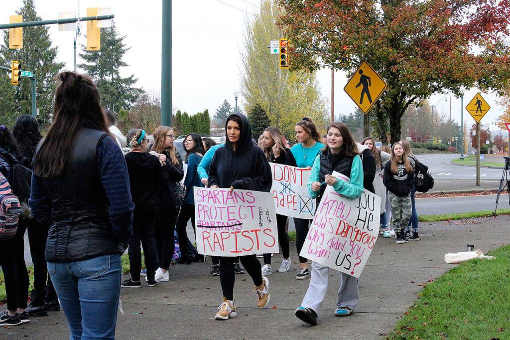Skyline High School students and community protest perpetuation of rape culture following ISD lawsuit. Faye Danyluk holds a sign that says, Spartans Protect Rapists. Madison Miller/staff photo.