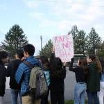 Skyline High School students and community protest perpetuation of rape culture following ISD lawsuit. Student holds a sign that says, Rape is not just a womans issue. Madison Miller/staff photo.