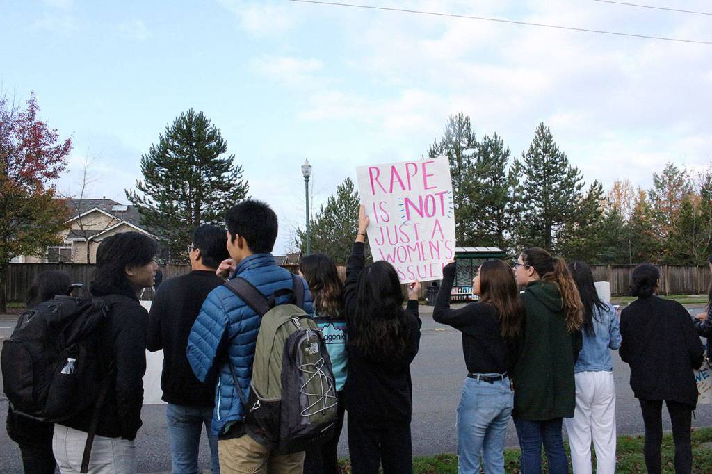 Skyline High School students and community protest perpetuation of rape culture following ISD lawsuit. Student holds a sign that says, Rape is not just a womans issue. Madison Miller/staff photo.