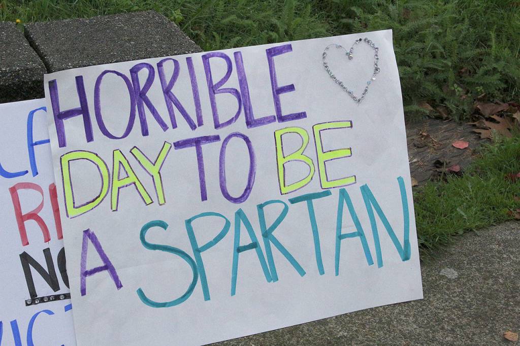 Skyline High School students and community protest perpetuation of rape culture following ISD lawsuit. Students designed signs to be seen throughout the demonstration. This sign says, Horrible day to be a Spartan. Madison Miller/staff photo.