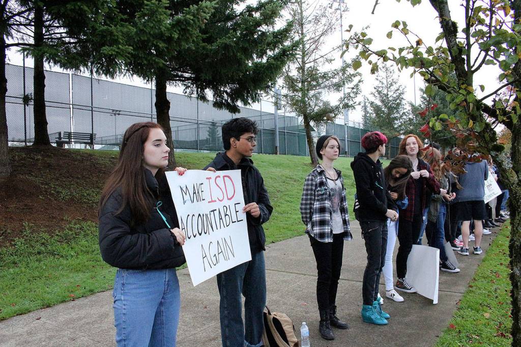 Skyline High School students and community protest perpetuation of rape culture following ISD lawsuit. From left: 2017 Skyline HS graduate, Sophie Truax, and senior Ayush Varadhan. Both holding a sign that says Make ISD Accountable Again. Madison Miller/staff photo.