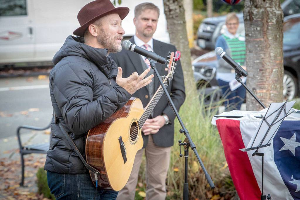 Kurt Dyrhsen, Music Director at Sammamish Presbyterian Church, led the attendees in song, first with Its a Long Way to Tipperary, a traditional WWI march song, and American the Beautiful. MC Dr. Paul Dean is looking on. Photo courtesy of Dennis Crane/DBC Photo.