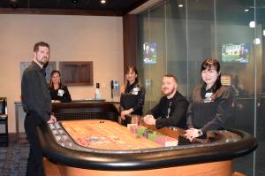 Snoqualmie Casino staff members surround a gaming table in the new private gaming room at Snoqualmie Casino. Photo courtesy of Tarah Smigun                                Snoqualmie Casino staff members (from left) Trevor House, Linda Yem, Sophorn Seng, Ross Garmon and Jan Wu surround a gaming table in the new private gaming room at Snoqualmie Casino. Photo courtesy of Tarah Smigun