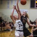 Issaquah Eagles freshman Mercedes Tinder (pictured) battles in the paint for a loose ball against Mercer Island junior Grace Shaddle in a non-league contest on Nov. 30. Issaquah defeated Mercer Island 69-20. Photo courtesy of Don Borin/Stop Action Photography