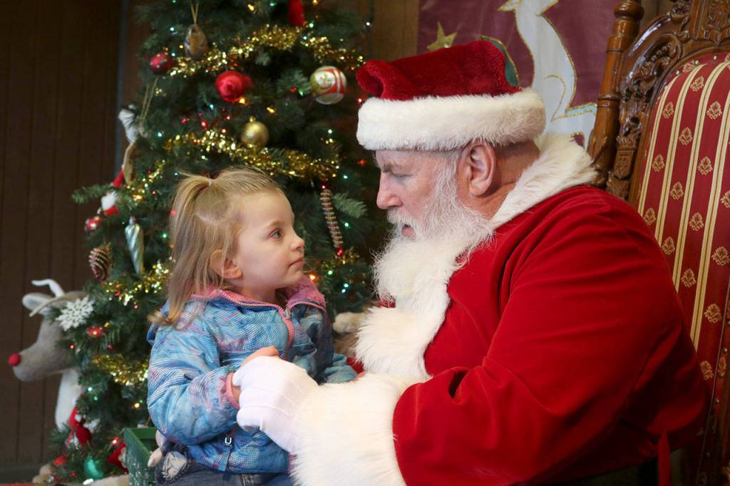 Raelynn Thukaram meets Santa at the Cougar Mountain Zoo Reindeer Festival. Evan Pappas/Staff Photo