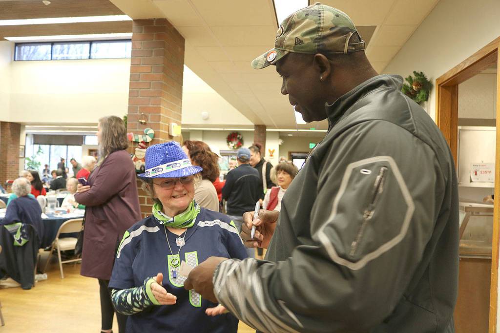 An Issaquah senior is starstruck as Alonzo Mitz signs an autograph.
