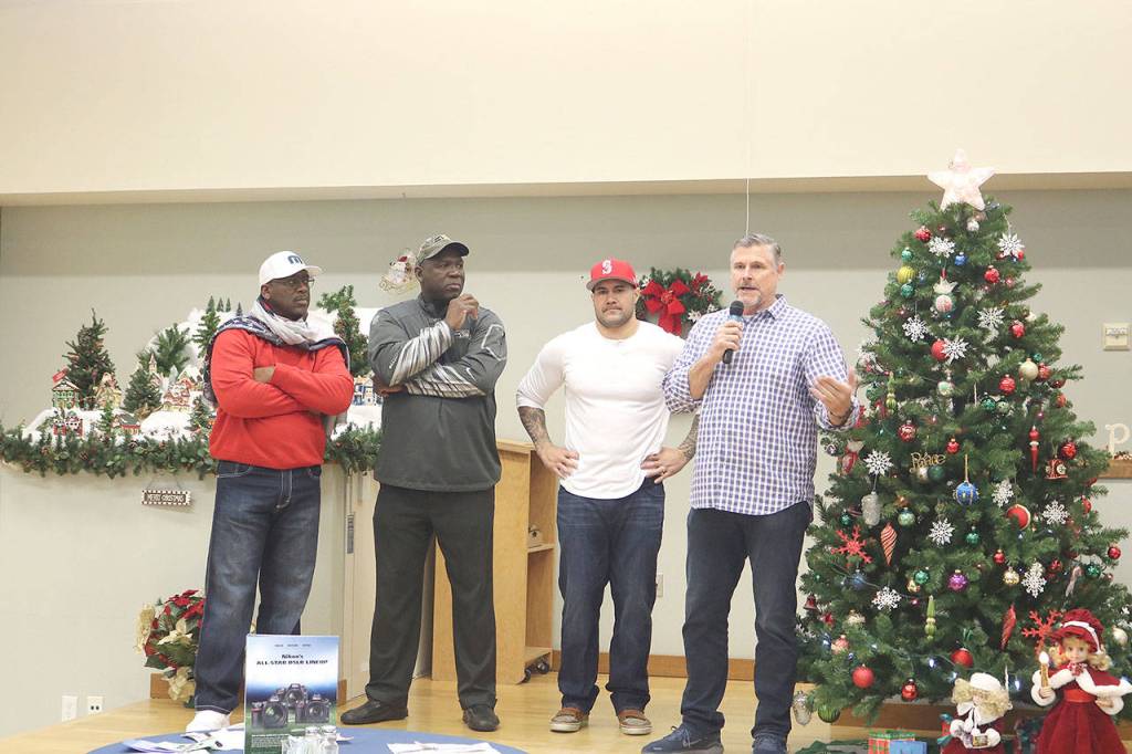 L-R: Randall Morris, Alonzo Mitz, Lofa Taupu, and Dave Wyman share their favorite football memories with the seniors of Issaquah Senior Center. Stephanie Quiroz/staff photo.