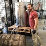 Matt Glenn stands next to one of Highsides distilling machines. Photo courtesy of Matt Glenn.
