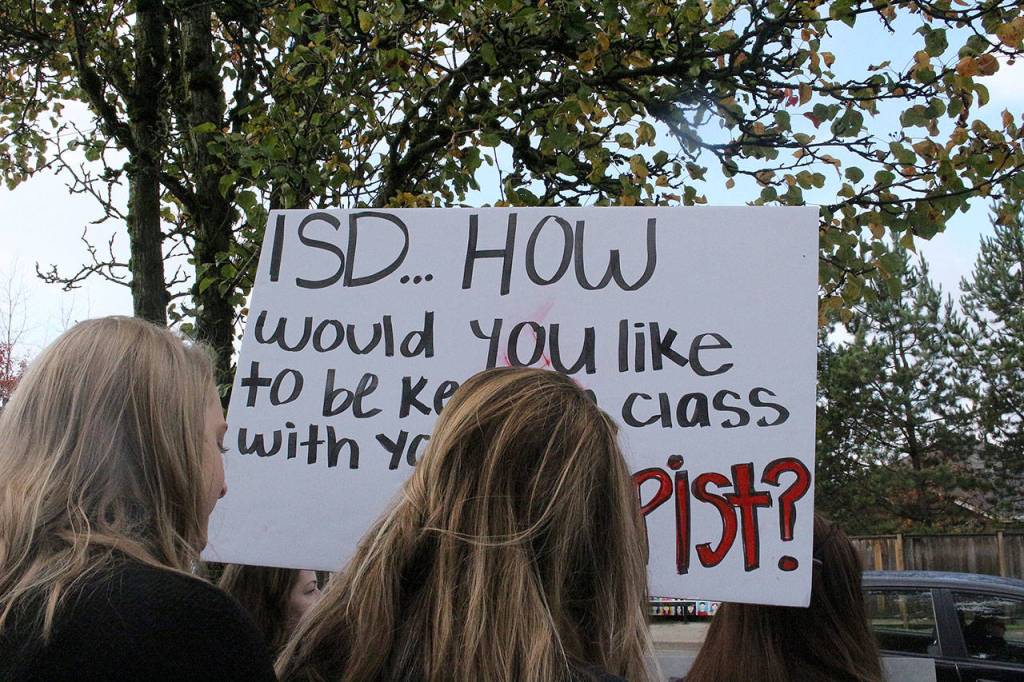 Skyline High School students and community protest perpetuation of rape culture following ISD lawsuit. Student holds sign that says ISD…How would you like to be kept in class with your rapist? Madison Miller/staff photo.
