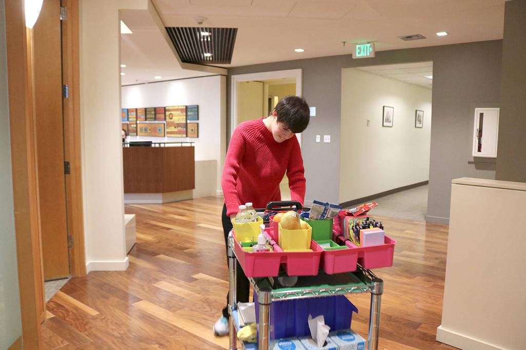 Paige Bisbee, of Bellevue is a paid employee at Davis Wright Tremaine in Bellevue. As part of the law firms inclusive program, Bisbee distributes snacks and office supplies to her co-workers. Stephanie Quiroz/staff photo.