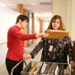 AtWork! employment counselor Emily Lord helps Paige Bisbee navigate around the office with her cart. Bisbee delivers snacks, office supplies, and mail to her co-workers at Davis Wright Tremaine in Bellevue. Stephanie Quiroz/staff photo.
