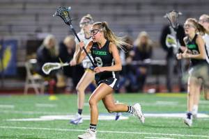 Issaquah sophomore McKenna Minnoch (pictured) carried the ball down the field against the Wolverines. Photo courtesy of Rick Edelman/Rick Edelman Photography