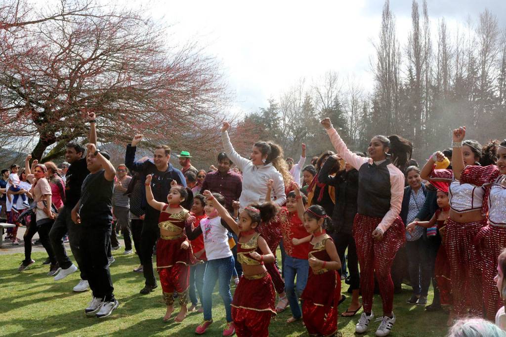 The large crowd begins to follow along to the dance performed on stage. Evan Pappas/Staff Photo