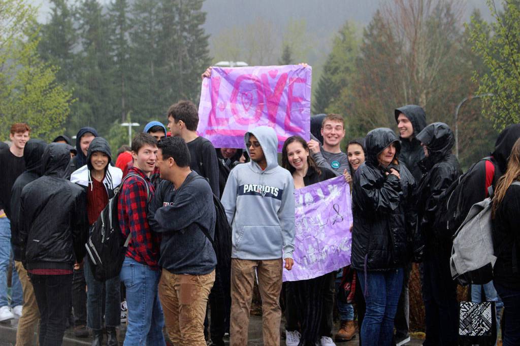 IHS students walkout to protest racist post on Wednesday with a sign that says Love. Madison Miller / staff photo