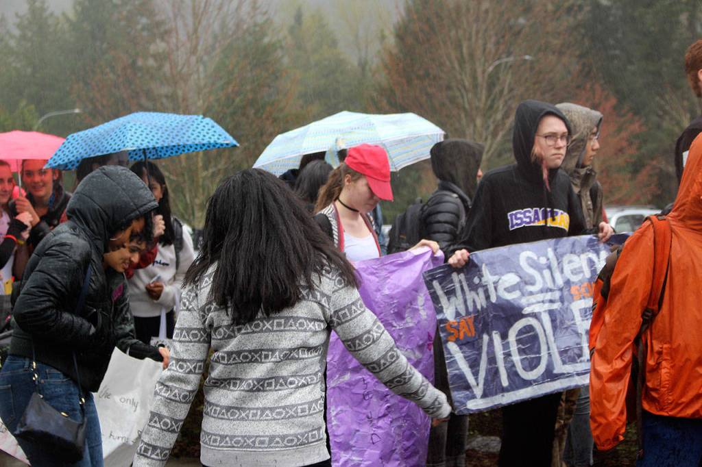 IHS students walkout to protest racist post on Wednesday with a sign that says White Silence Equals Violence. Madison Miller / staff photo