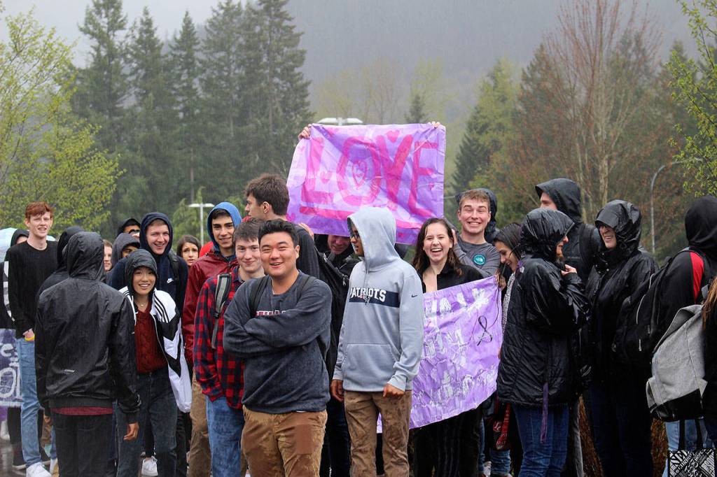 IHS students walkout to protest racist post on Wednesday with a sign that says Love. Madison Miller / staff photo