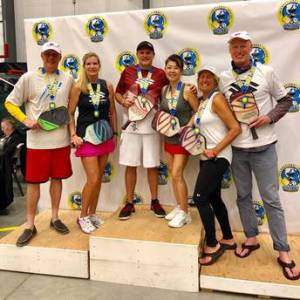 Issaquah resident Jay Rippel (center) and teammate Miok Lee of Gig Harbor earned first place in the mixed doubles senior open division in the 2019 International Indoor Pickleball Championships on March 31 at the Northwest Sports Hub in Centralia. Rippel also captured a silver medal in the mens doubles senior open with teammate Glen Peterson. Photo courtesy of Lessly Delcid