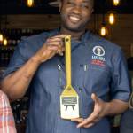 Levitate Gastropub executive chef Pa Jallow holds the golden spatula he won for creating the best Salmon-based appetizer for the Issaquah Epicurean Experience contest. Greater Issaquah Chamber of Commerce / courtesy photo