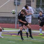Issaquah senior forward Gavin Herman battles with a Skyline player in front of the goal. Issaquah defeated Skyline, 3-1, to keep its season alive on May 7. Photo courtesy of Don Borin/Stop Action Photography