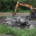 A city worker demolishes the old Issaquah Skate Park that was built in 1997 outside of the Issaquah Community Center.