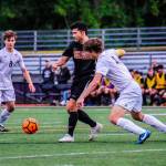 Issaquah Eagles senior Taiga Crenshaw (No. 10) is surrounded by a bevy of Mount Si Wildcats players in the 4A state quarterfinals on May 18 at Gary Moore Stadium in Issaquah. Photo courtesy of Don Borin/Stop Action Photography